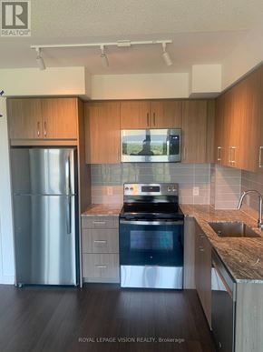 Toronto (Humber Heights) condo for rent - A modern kitchen with wooden cabinets and stainless steel appliances.
