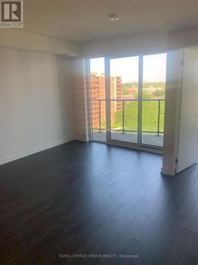 Toronto (Humber Heights) condo for rent - A room with a view of a balcony and a building outside.