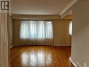 St. Catharines (Bunting/Linwell) apartment for rent - A room with wooden floors and a window with curtains.