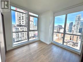 Toronto (Waterfront Communities) condo for rent - A room with a view of the cityscape through large windows.