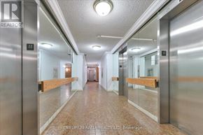 Toronto (L'amoreaux) condo for rent - A hallway with a Realty sign on the door.
