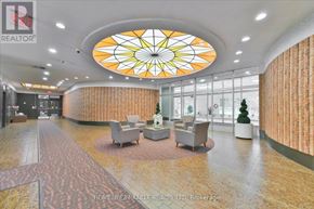 Toronto (L'amoreaux) condo for rent - A large, well-lit lobby with a circular stained glass window at the center.