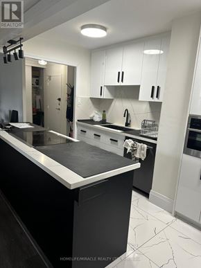 Toronto (L'amoreaux) condo for rent - A modern kitchen with black and white color scheme.