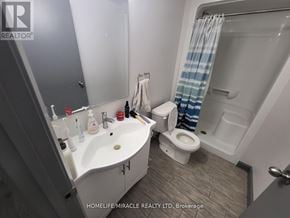 Waterloo condo for rent - A bathroom with a sink, toilet, and shower.