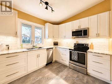 London East (East I) apartment for rent - A kitchen with white cabinets and a black stove top oven.