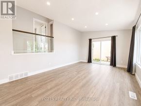 London East (East I) apartment for rent - A spacious room with wooden flooring and a sliding glass door leading to a balcony.