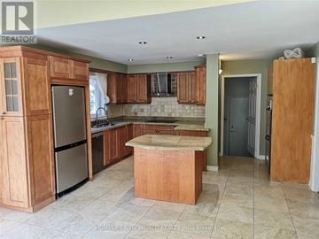 Markham (Unionville) apartment for rent - A kitchen with wooden cabinets and a marble countertop.