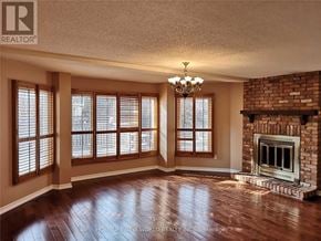 Markham (Unionville) apartment for rent - A room with a fireplace and a chandelier.