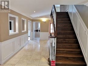 Markham (Unionville) apartment for rent - A staircase with a wooden banister and a tiled floor.