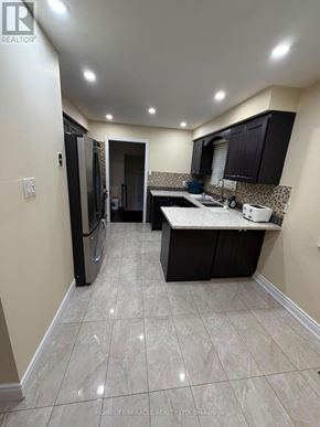 Brampton (Madoc) apartment for rent - A kitchen with black cabinets and a white countertop.