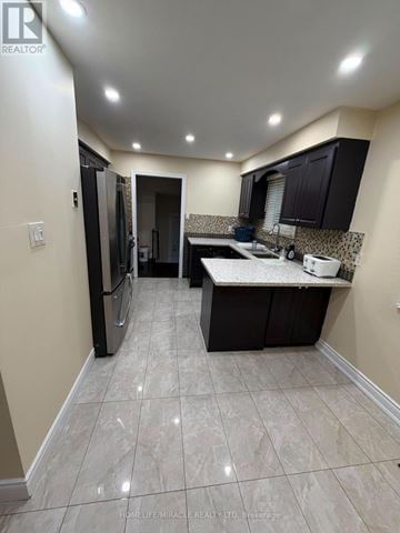 Brampton (Madoc) apartment for rent - A kitchen with black cabinets and a white countertop.