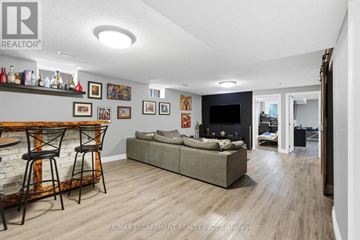 Hamilton (Rolston) apartment for rent - A living room with a grey couch and a bar area.