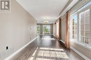 Richmond Hill (Rouge Woods) townhouse for rent - A long hallway with a rug on the floor and a chandelier hanging from the ceiling.