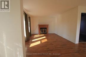 Innisfil apartment for rent - A room with a fireplace and wooden floors.