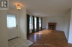 Innisfil apartment for rent - A room with a fireplace and sliding glass doors.