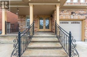 Brampton (Vales Of Castlemore) apartment for rent - A front porch with a black railing and steps leading to a glass door.