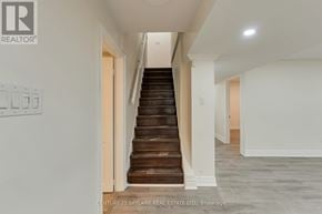Brampton (Vales Of Castlemore) apartment for rent - A staircase in a house with a logo on the wall.