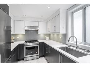 Delta apartment for rent - A modern kitchen with a stove top oven and a sink.