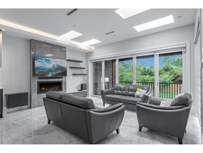 Delta apartment for rent - A modern living room with a fireplace and a large painting on the wall.