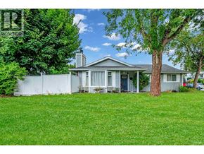 Maple Ridge apartment for rent - A house with a white fence and a tree in front of it.