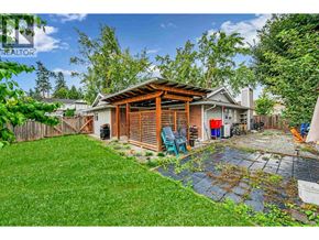 Maple Ridge apartment for rent - A backyard with a wooden deck and a patio.