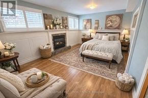 Wasaga Beach apartment for rent - A bedroom with a fireplace and a bed.