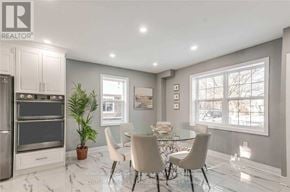 Oakville (Cp College Park) apartment for rent - A modern kitchen with a dining table set for four.