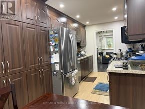 Mississauga (Meadowvale) apartment for rent - A kitchen with wooden cabinets and a stainless steel refrigerator.