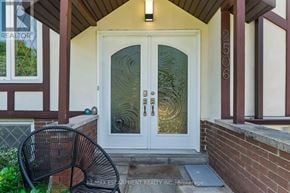 Oakville (Wo West) apartment for rent - A glass door with a metal handle is on the front of a house.