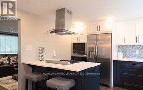 Cambridge apartment for rent - A modern kitchen with a stainless steel refrigerator and a white island.