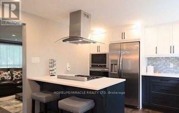 Cambridge apartment for rent - A modern kitchen with a stainless steel refrigerator and a white island.