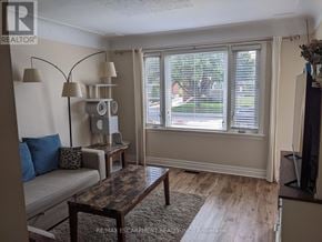 Hamilton (Rosedale) apartment for rent - A living room with a couch, a table, and a window with blinds.