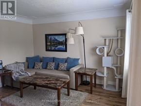 Hamilton (Rosedale) apartment for rent - A living room with a couch, coffee table, and a painting on the wall.