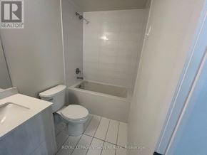Richmond Hill (Crosby) condo for rent - A white bathroom with a toilet, sink, and bathtub.