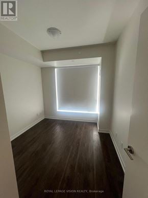 Richmond Hill (Crosby) condo for rent - A room with wooden floors and a window letting in light.