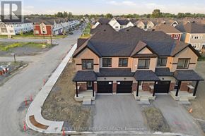 Ottawa townhouse for rent - A new home under construction with a garage door open.