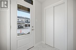 Ottawa townhouse for rent - A white door with a glass window showing a street view.