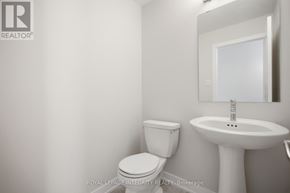 Ottawa townhouse for rent - A white toilet and sink in a small bathroom.