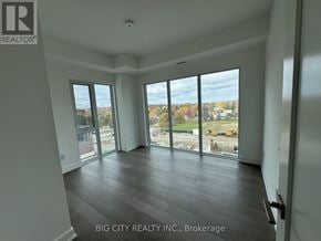 Newmarket (Huron Heights-Leslie Valley) condo for rent - A room with a view of a construction site through the windows.