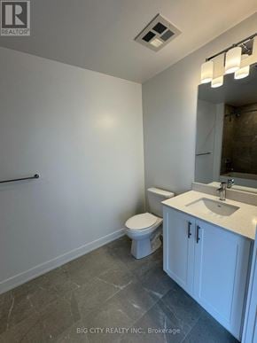 Newmarket (Huron Heights-Leslie Valley) condo for rent - A white bathroom with a toilet, sink, and mirror.