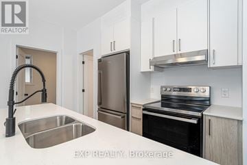 Ottawa multi-family for rent - A kitchen with white cabinets and stainless steel appliances.