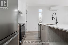 Ottawa multi-family for rent - A kitchen with a refrigerator and a sink.