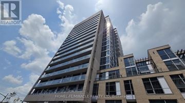 Burlington (Uptown) condo for rent - A tall building with the words "HOMELIFE MIRACLE REALTY LTD. Brokerage" on its side.