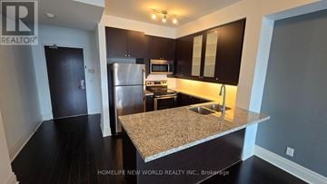 Markham (Unionville) condo for rent - A kitchen with granite countertops and stainless steel appliances.