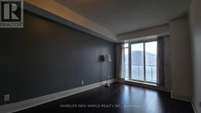 Markham (Unionville) condo for rent - A room with a lamp and a window with a view of a building outside.