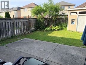 Kitchener apartment for rent - A backyard with a fence and a small shed.