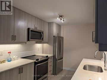 Vaughan (Concord) townhouse for rent - A kitchen with a sink, microwave, and refrigerator.