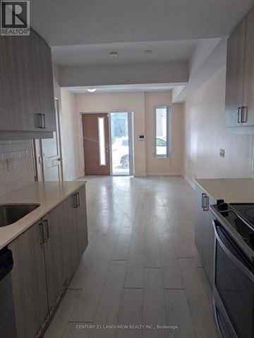 Vaughan (Concord) townhouse for rent - A kitchen with light grey cabinets and a white counter top.