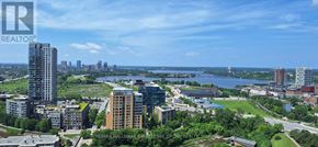 Ottawa condo for rent - A view from a high-rise building looking out over a cityscape and a river.