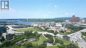 Ottawa condo for rent - A cityscape with a body of water in the distance and a sign that says REALTOR.
